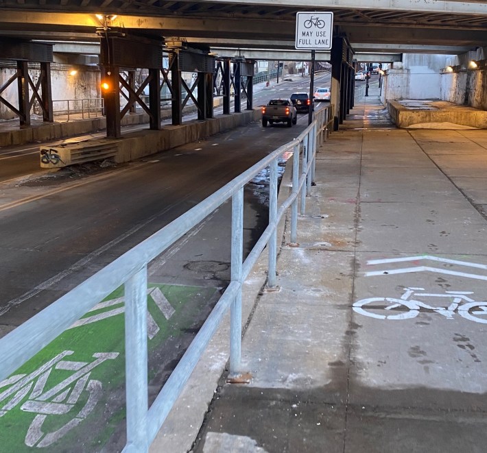 The signs and markings indicate that bike riders can use the sidewalk, ride on top of the on-street sharrows, or ride in the middle of the travel lane. Photo: Twitter user @babygluckling.