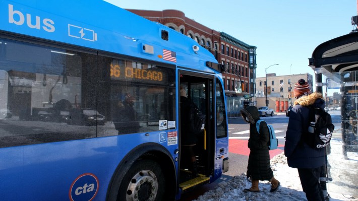 Boarding an electric bus on Chicago Avenue in West Town this winter. Photo: CTA