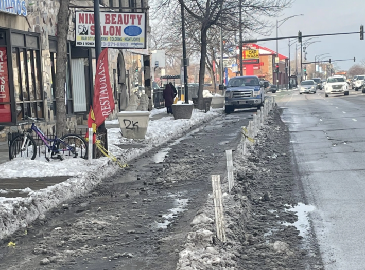 The Clark bike lanes now have more posts, but they're still often filled with snow and/or blocked by illegally parked vehicles. Photo: Courtney Cobbs