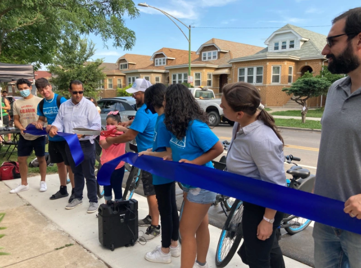 Residents cut the ribbon on new Divvy stations and bike lanes, with locations influenced by community input, in Belmont Cragin last August. Photo: John Greenfield