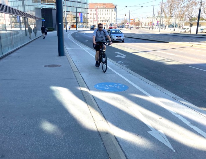 A bike lane between street and sidewalk level in Vienna. Photo: John Greenfield