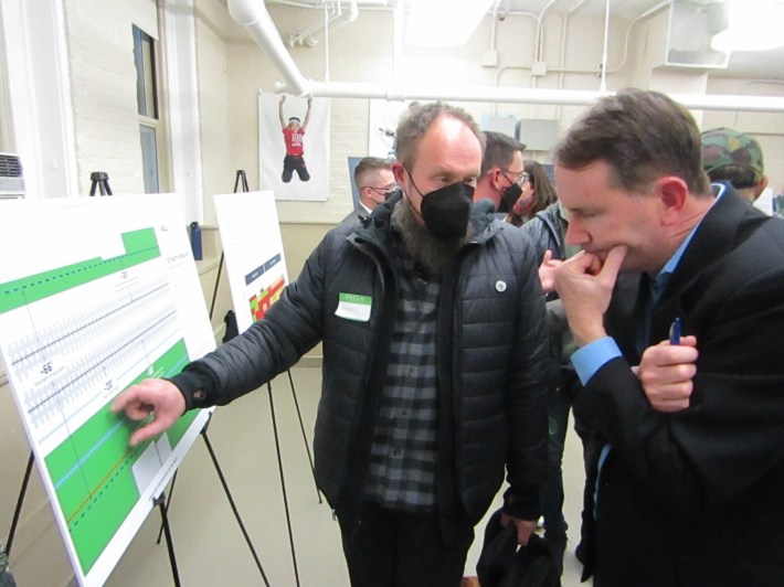 Craig Gunderson (left) tells project official that the new west track was too close to the houses to the west