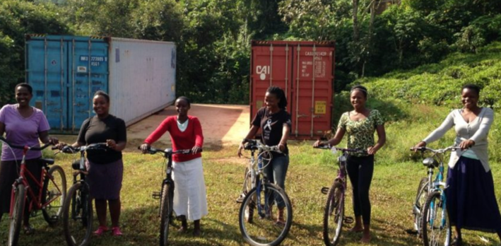 Women in front of bicycle shipping containers in Bwindi. Photo: BWBE