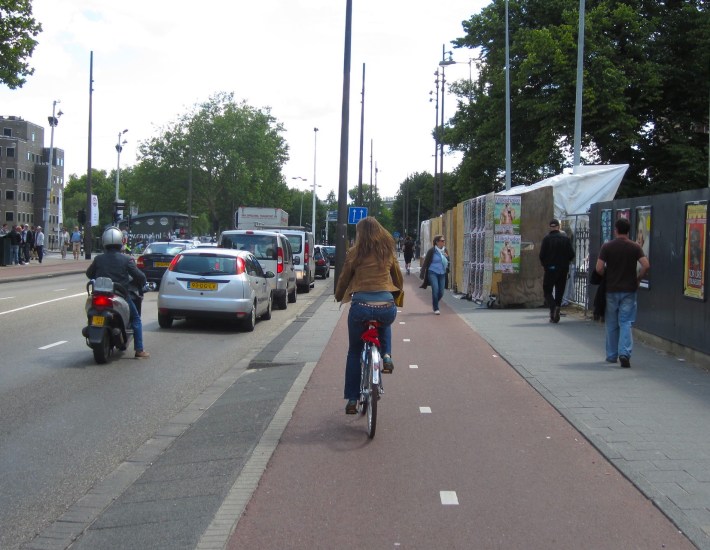 A raised bike lane in Amsterdam. In the Netherlands, bike riders are never required to share the road with fast traffic. Photo: John Greenfield