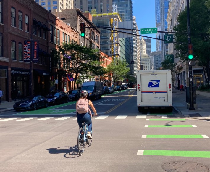 The illegally parked postal truck, forcing a bike rider to use the travel lane. Photo: John Greenfield