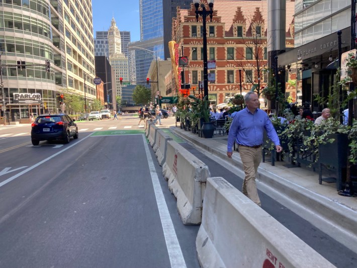 To accommodate the giant sidewalk cafe for Siena Tavern, pedestrians are detoured into the street, which means people biking have to ride in the middle of the travel lane. Photo: John Greenfield