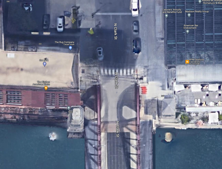 There's a midblock crosswalk just north of the Clark bridge with a stoplight for southbound traffic, but no signal for northbound bike riders using the temporary contraflow bike lane. Image: Google Maps