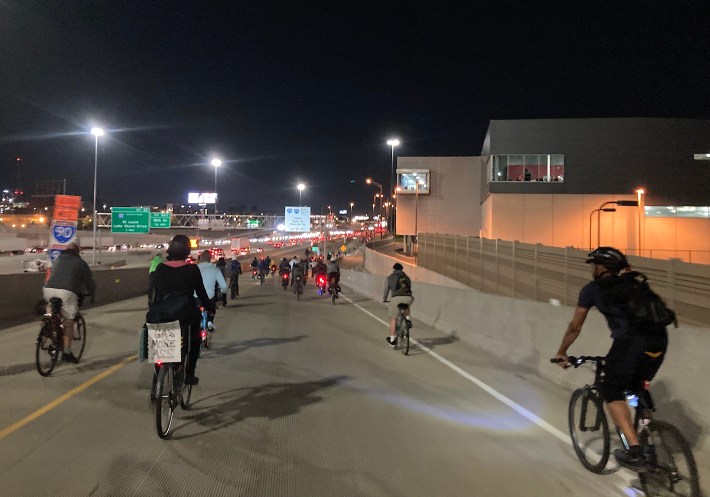 Exciting the expressway system on an off-ramp north of Taylor Street. A rider's sign, left over from Chicago's World Naked Bike Ride last June, reads "Less Gas, More Ass." Photo: John Greenfield