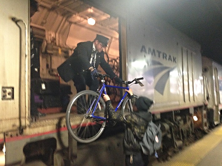 Passing a bike up to the conductor in an Amtrak baggage car. Photo: John Greenfield