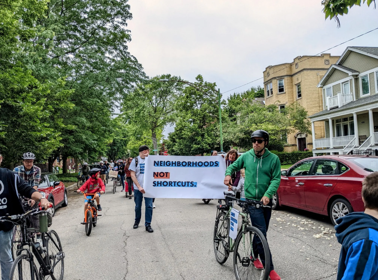 A “Neighborhoods Not Shortcuts” sign at the rally. Photo: Eric Allix Rogers