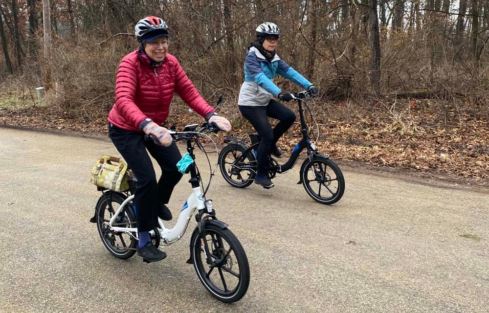 Sharon Kaminecki, left, rides an e-bike with a friend. Photo: Bob Kaminecki