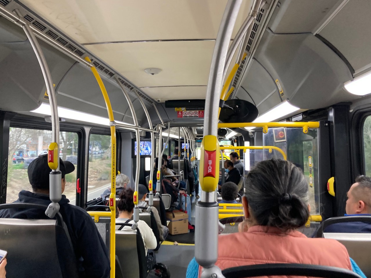Onboard an Orange Line articulated bus. Surveillance camera monitors inside the bus remind passengers their actions are being filmed, which may help deter crime. Photo: John Greenfield