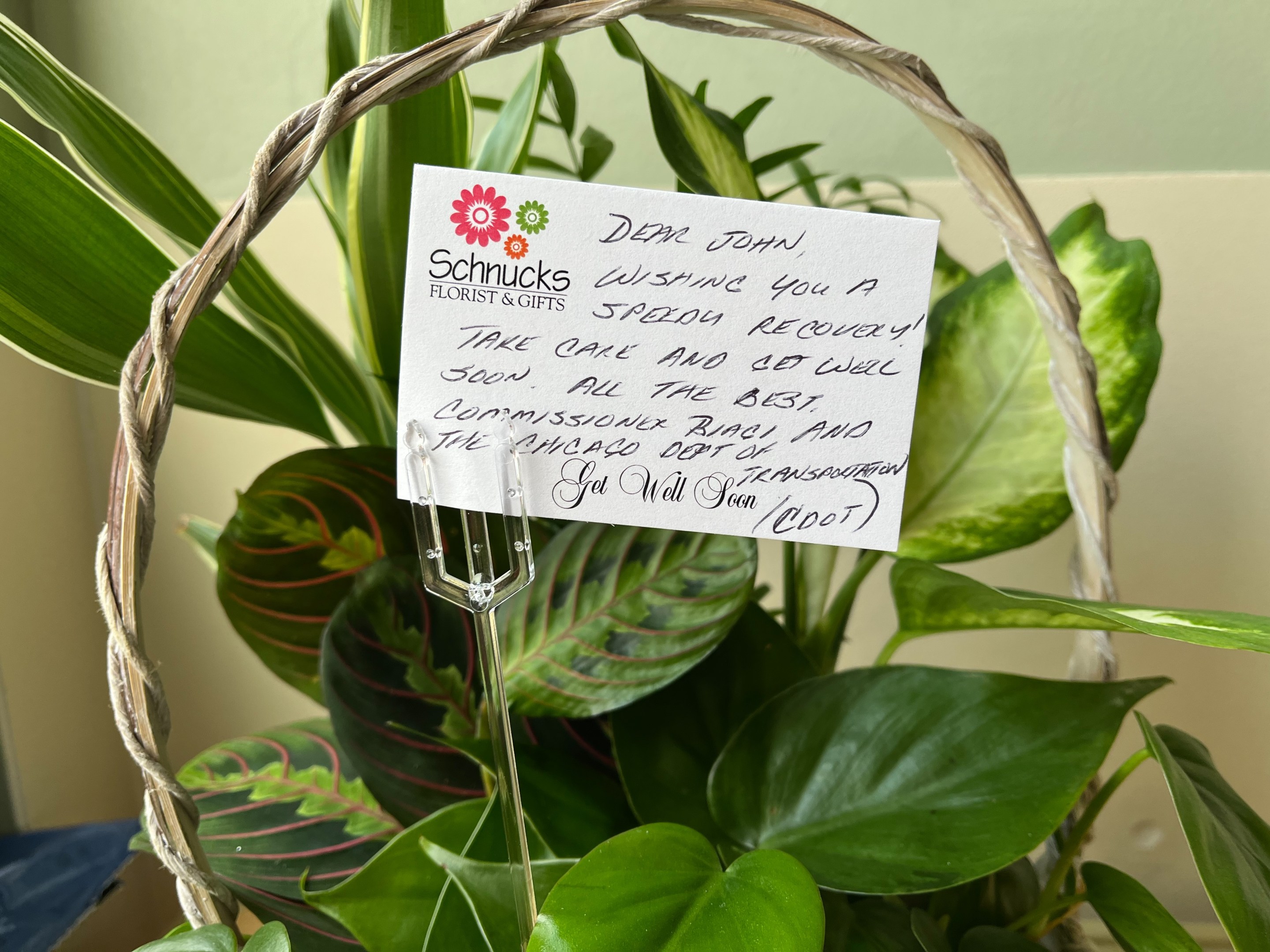 A planter with a handwritten card.