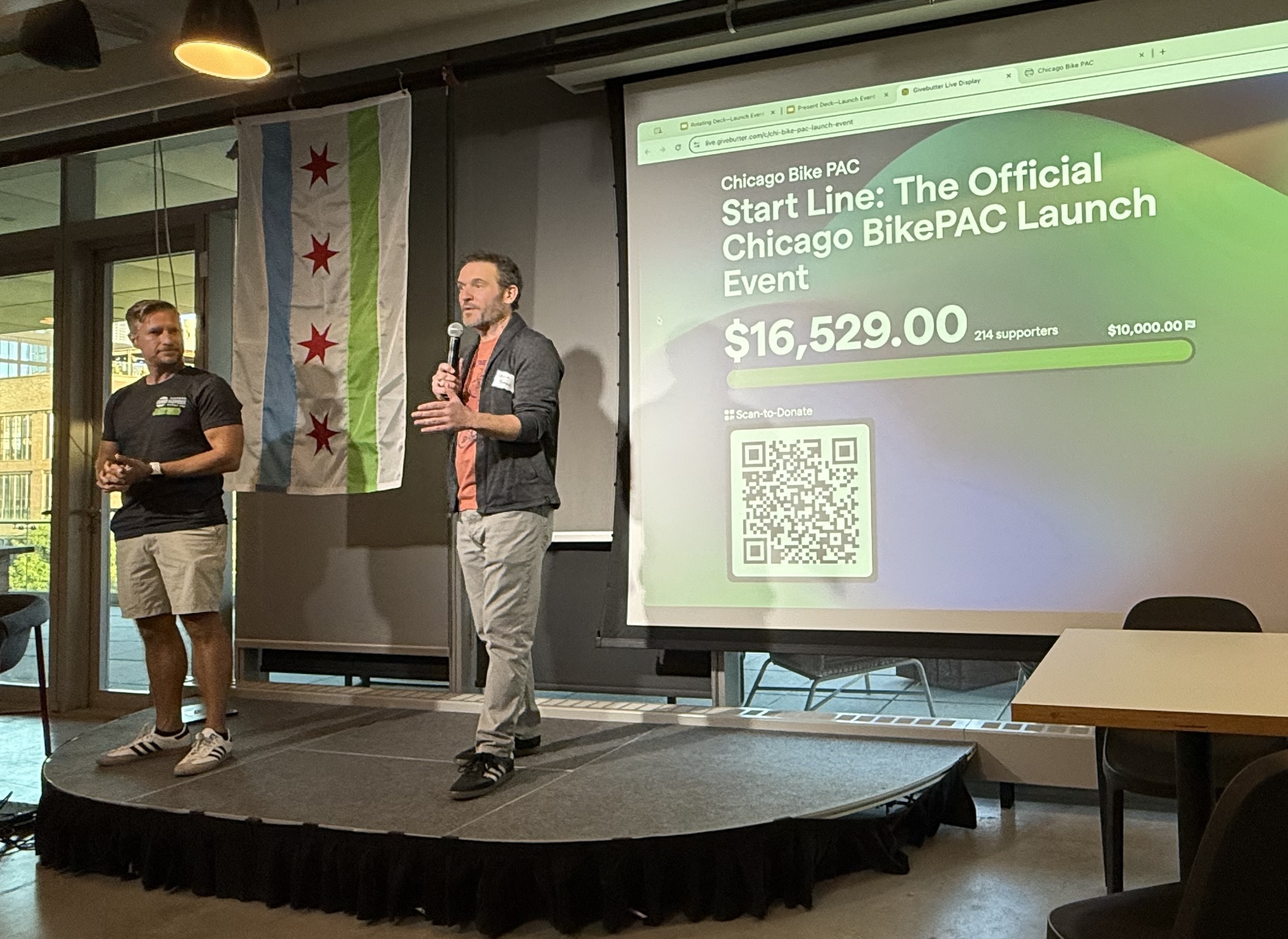 Chris Ridgeway and Kevin Borgia standing on a small stage in front of a presentation screen.